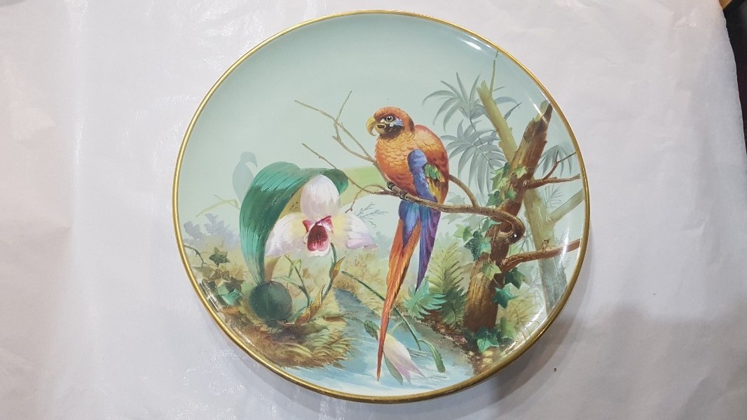 Discover our collection of antique ceramics, like this 1890 hand-decorated plate by B. Stuart. Adorned with colorful exotic birds, it measures 31 cm. Shop now!