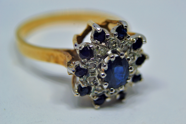 Discover vintage elegance with our 9ct gold ring, featuring a sapphire & diamond cluster. Hallmarked London 1978. Shop now for unique, timeless luxury!