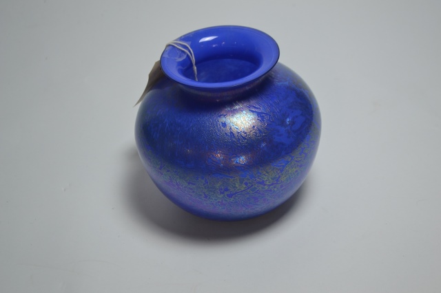 Explore our stunning range of Royal Brierley studio glass, featuring captivating blue, iridescent designs. Standing at 18cm high, it's the perfect addition to any decor. Shop now!