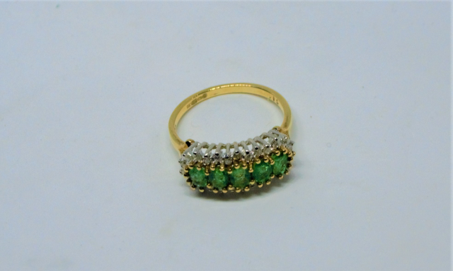 Discover our 9ct gold ring, studded with emeralds and diamonds. Expertly crafted in Sheffield. Weighs 2.9g, size N. Shop now to add a touch of luxury to your collection.