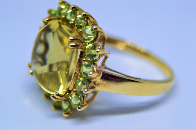 Discover our stunning 9ct gold ring with a peridot cluster. Sized T, weigh 5.3g and hallmarked in Birmingham. Shop now for this unique piece!