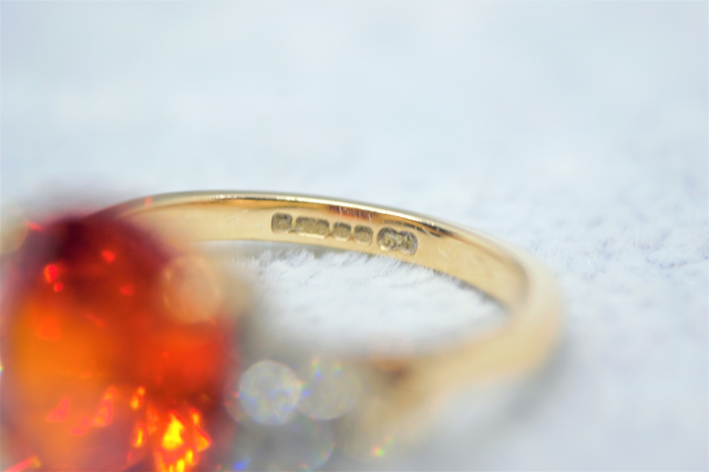 A 9ct Yellow  Gold And synthetic Orange spinel and White Sapphire Dress Ring. 