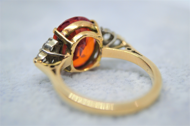 A 9ct Yellow  Gold And synthetic Orange spinel and White Sapphire Dress Ring. 