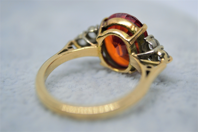A 9ct Yellow  Gold And synthetic Orange spinel and White Sapphire Dress Ring. 