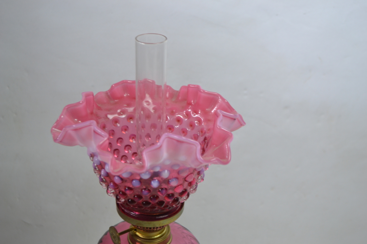 Discover our Art Nouveau style French Daudard brass oil lamp. Featuring a cranberry glass reservoir and dimpled shade. 50cm high. In premium condition. Shop now!