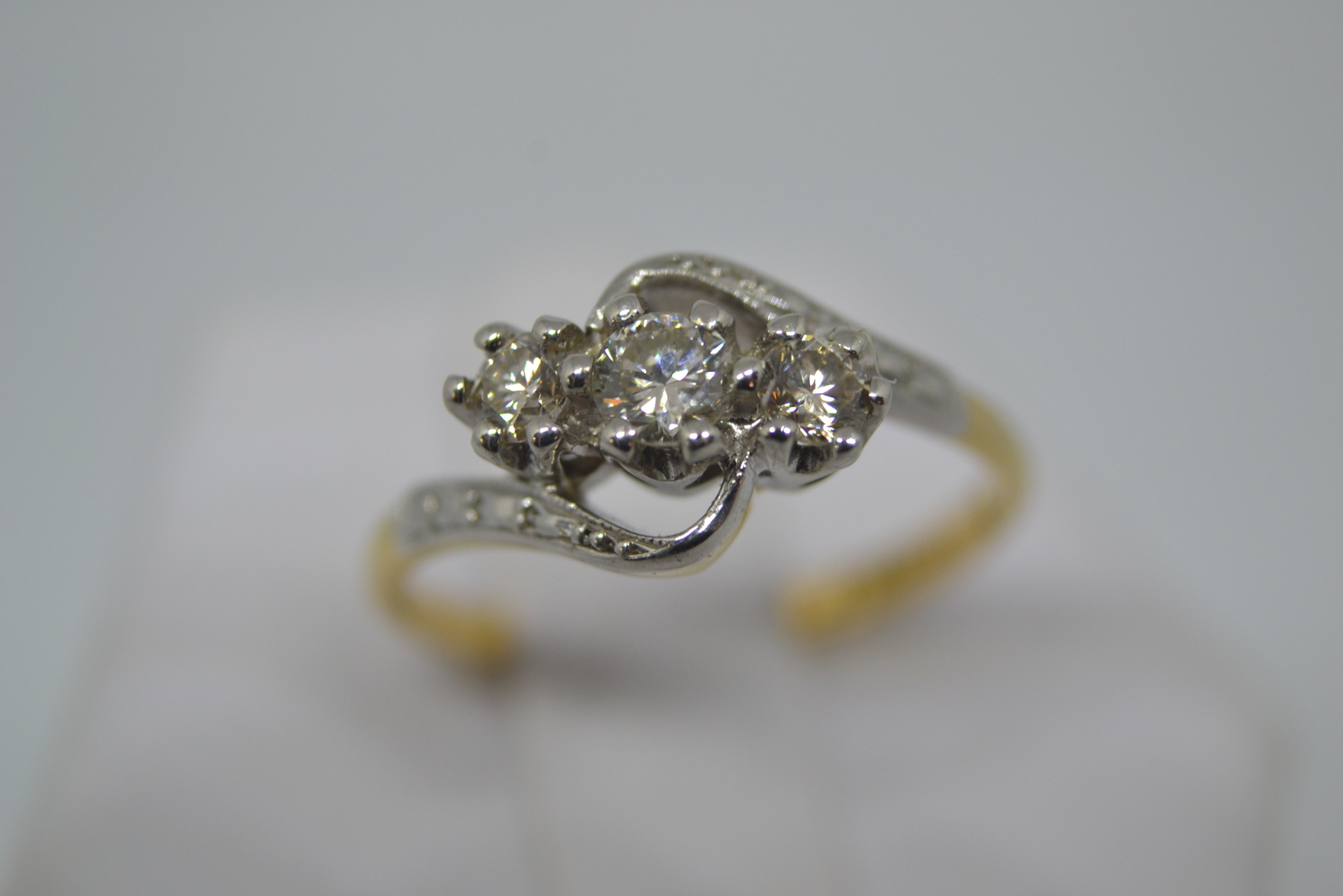 Discover our elegant 18ct platinum, 3-stone diamond crossover ring. Perfect for discerning jewelry lovers, this size O, approx. 2.5g treasure waits for you. Shop now!