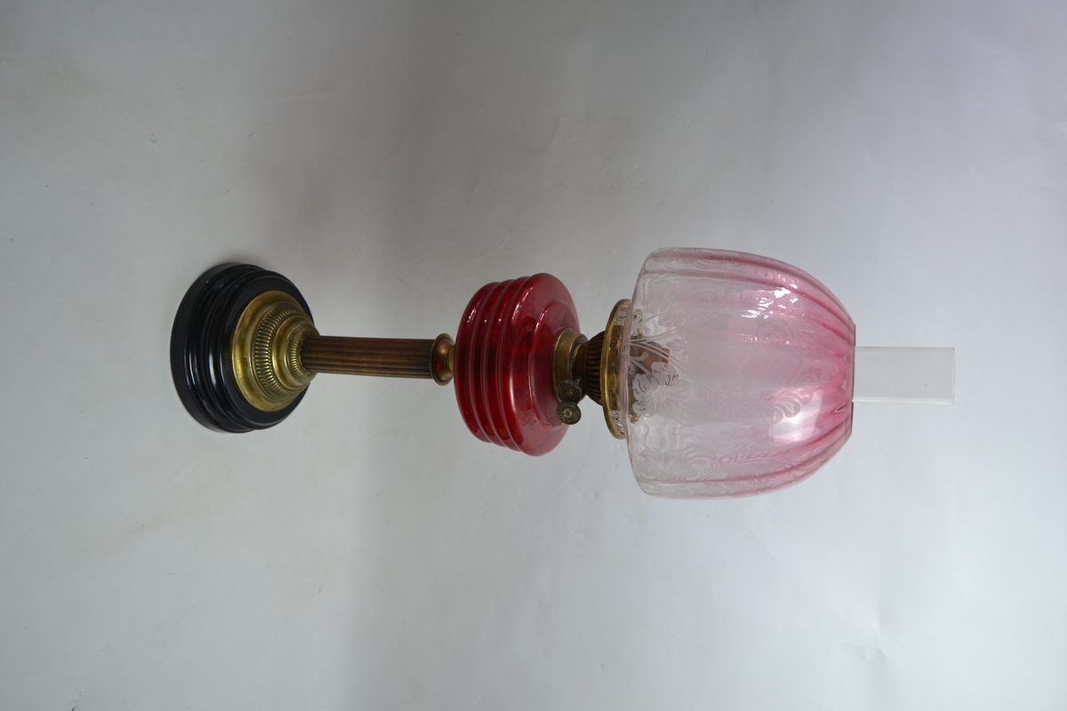 Discover our collection of exquisite Victorian cranberry glass oil lamps. This particular 27 piece boasts a unique wooden and brass stand. Shop now for antique treasures!