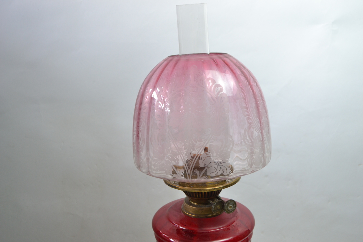 Discover our collection of exquisite Victorian cranberry glass oil lamps. This particular 27 piece boasts a unique wooden and brass stand. Shop now for antique treasures!