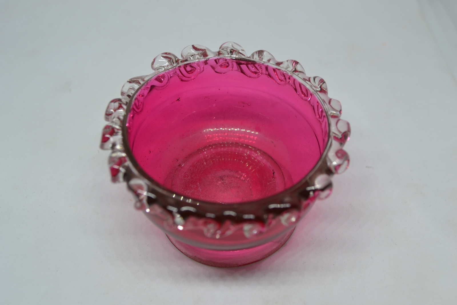 Discover our unique collection of 19th century cranberry salts. Each piece boasts intricate designs and rich color. Shop now for vintage tableware!