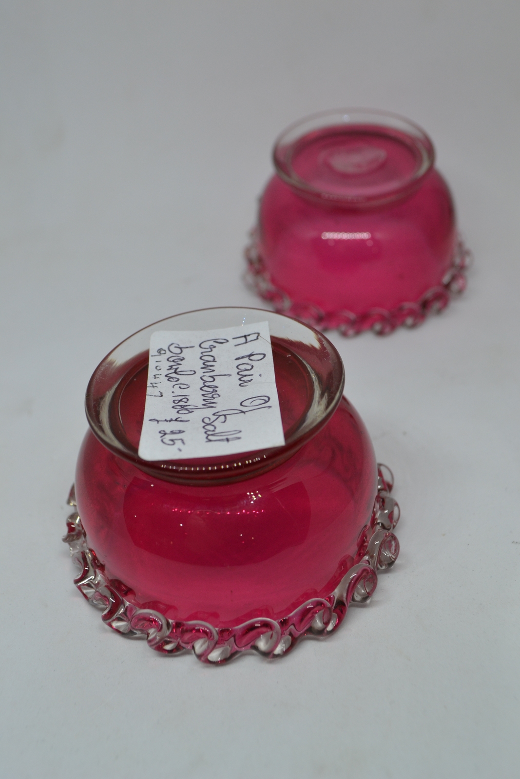 Discover our unique collection of 19th century cranberry salts. Each piece boasts intricate designs and rich color. Shop now for vintage tableware!