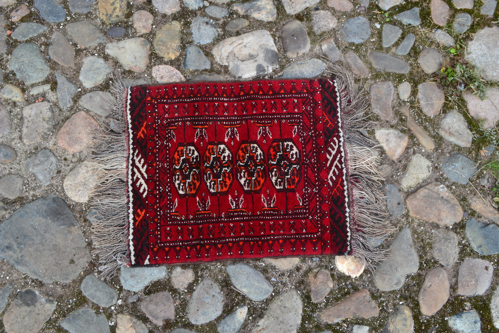 Discover our unique Bokhara pattern prayer mats in a striking red ground. Sized perfectly at 60cm x 50cm, they're too good to miss! Shop now.