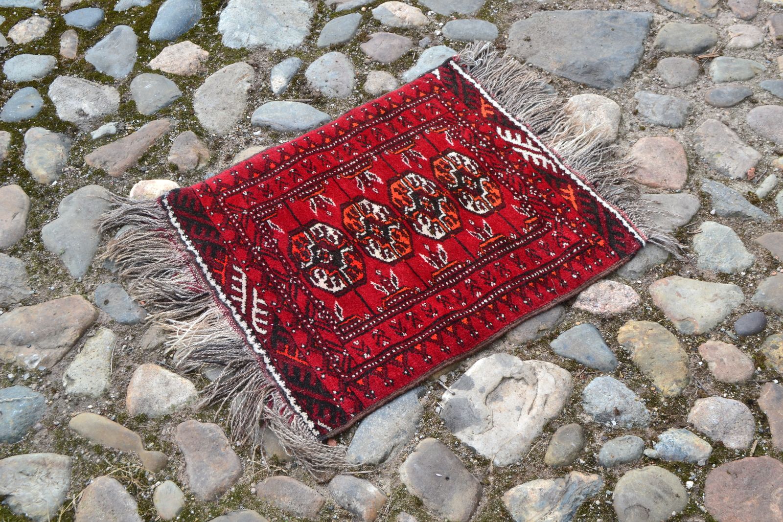 Discover our unique Bokhara pattern prayer mats in a striking red ground. Sized perfectly at 60cm x 50cm, they're too good to miss! Shop now.