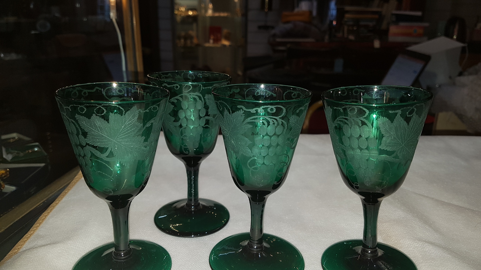 Discover our collection of 19th-century handblown Bristol green wine glasses. Engraved with unique vine leaves design and standing 13 cm high. Shop now for these one-of-a-kind pieces!