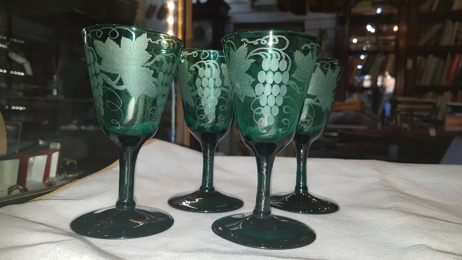 Discover our collection of 19th-century handblown Bristol green wine glasses. Engraved with unique vine leaves design and standing 13 cm high. Shop now for these one-of-a-kind pieces!