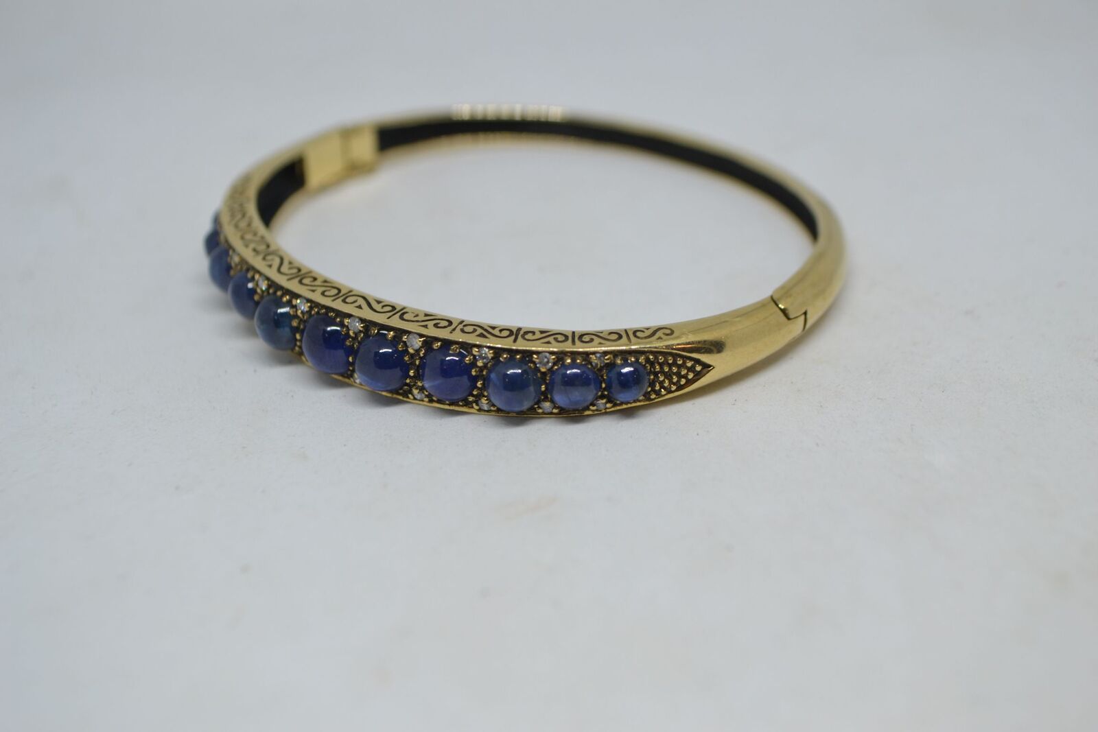 Shop our exquisite 9ct yellow gold sapphire bangle, accented with 11 sapphires, weighs 16g. See more details and order yours today!