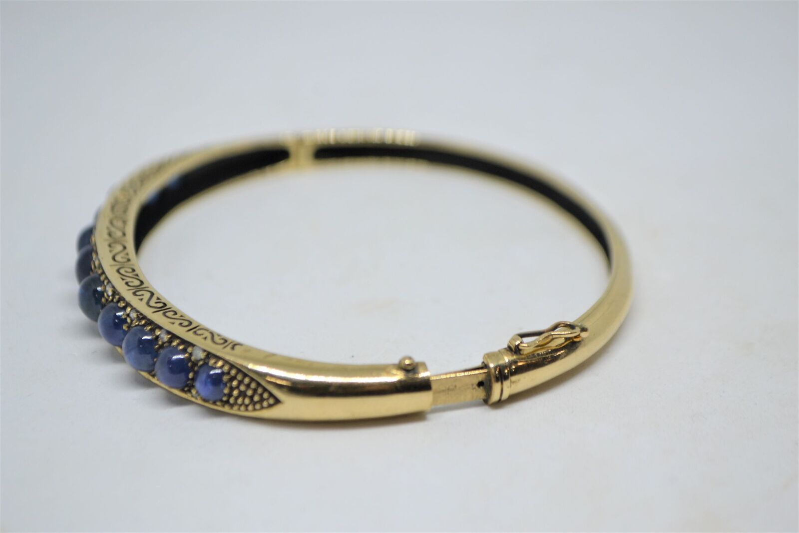 Shop our exquisite 9ct yellow gold sapphire bangle, accented with 11 sapphires, weighs 16g. See more details and order yours today!