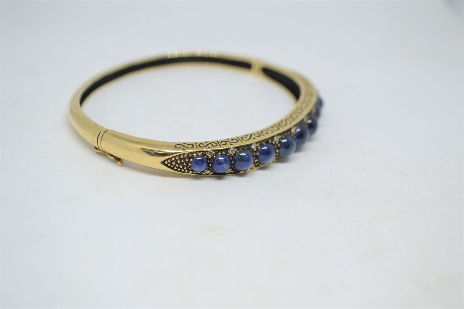 Shop our exquisite 9ct yellow gold sapphire bangle, accented with 11 sapphires, weighs 16g. See more details and order yours today!