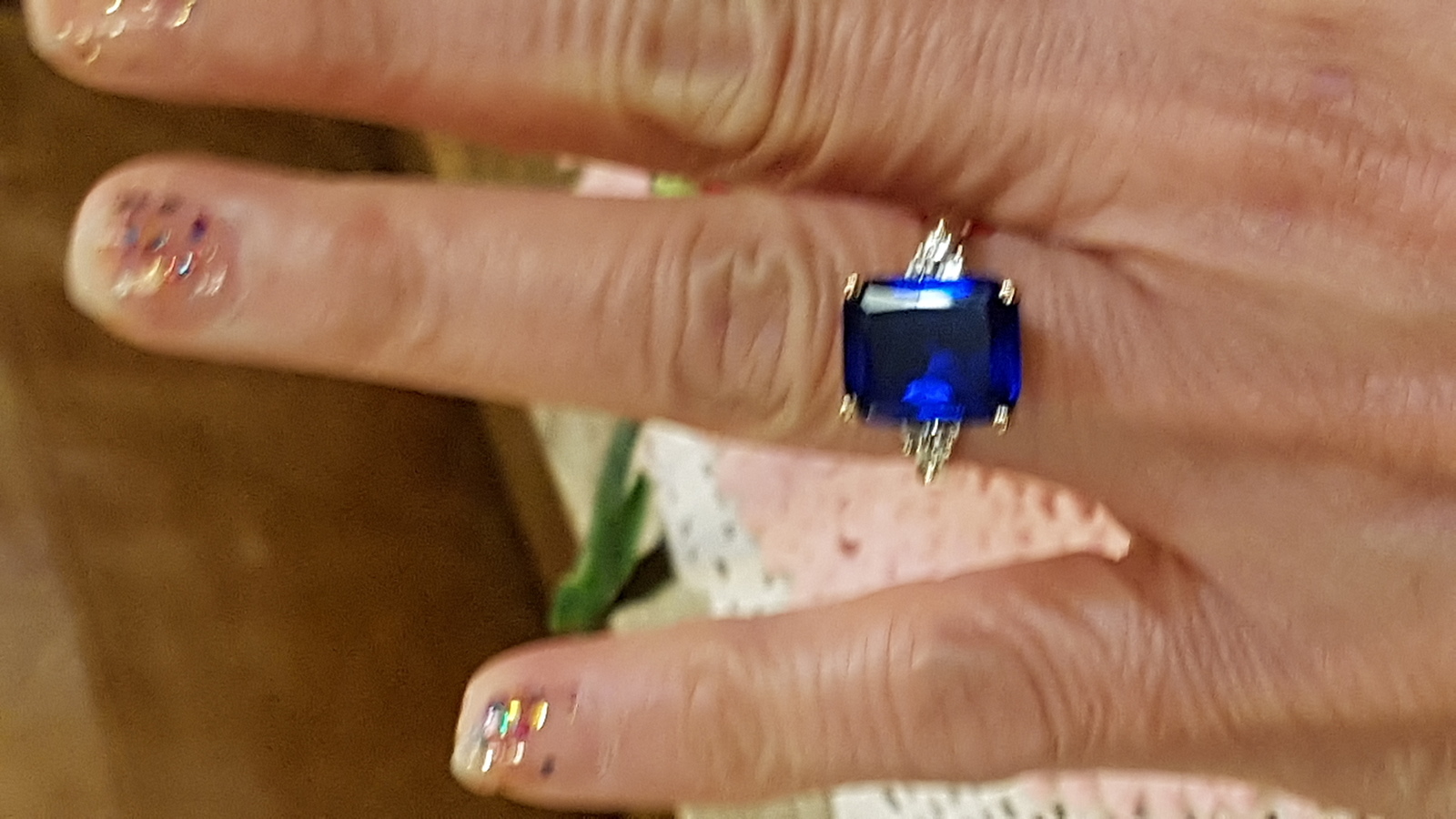 Explore our collection of 9ct yellow gold rings, featuring a stunning emerald cut Spinel adorned with Cubic Zirconia. Shop now for your perfect fit in size M.