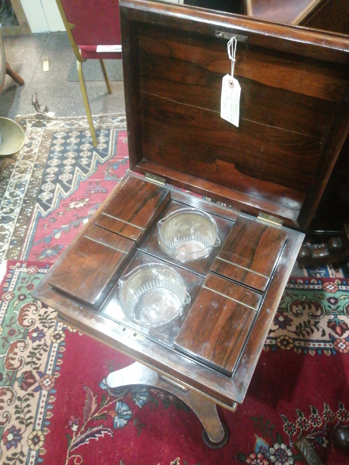 Discover our stunning Victorian rosewood pedestal teapoy. Perfect for tea enthusiasts, its unique design includes four tea canisters and two mixing bowls. Shop now, cherish your tea moments!