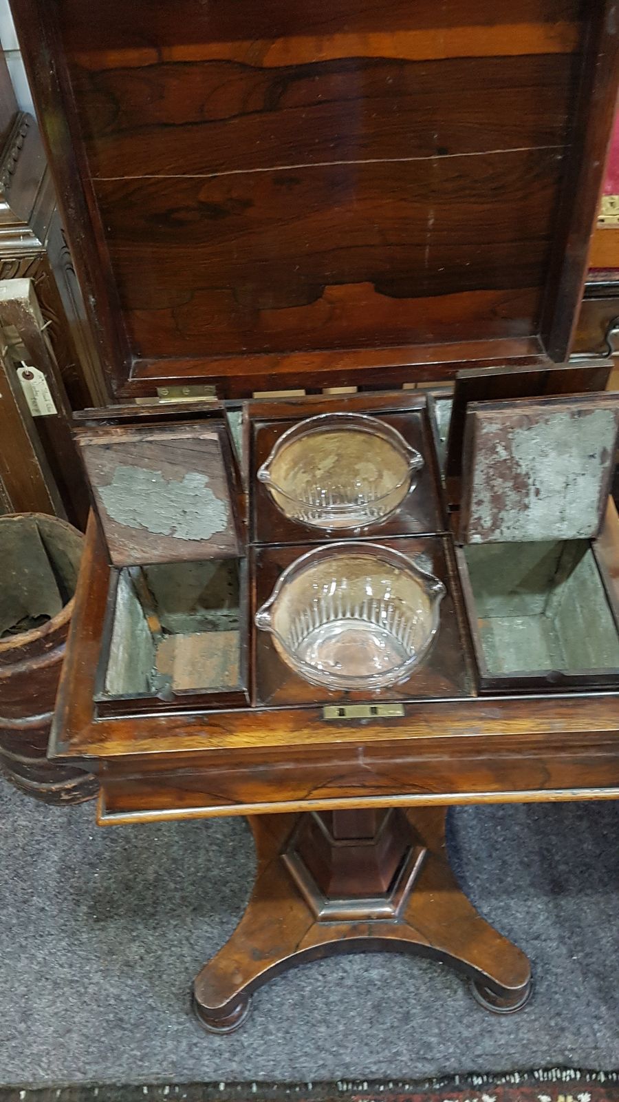 Discover our stunning Victorian rosewood pedestal teapoy. Perfect for tea enthusiasts, its unique design includes four tea canisters and two mixing bowls. Shop now, cherish your tea moments!