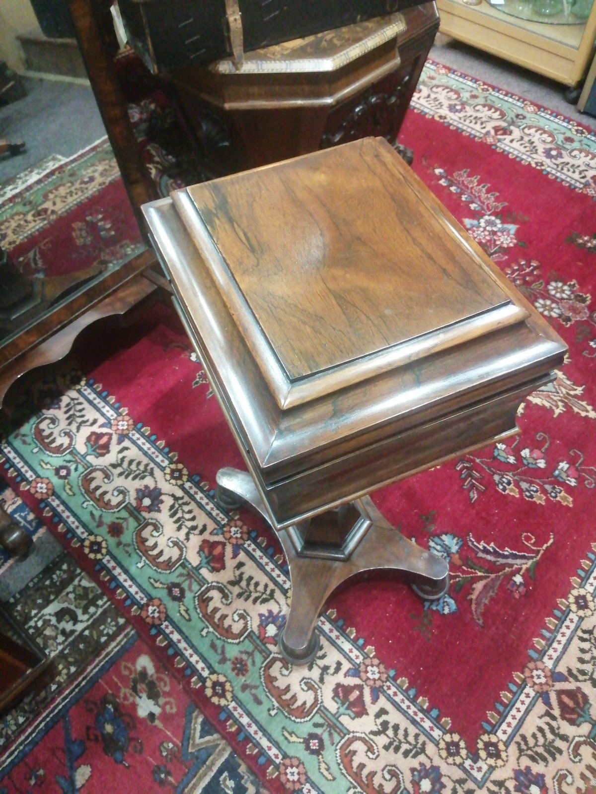 Discover our stunning Victorian rosewood pedestal teapoy. Perfect for tea enthusiasts, its unique design includes four tea canisters and two mixing bowls. Shop now, cherish your tea moments!