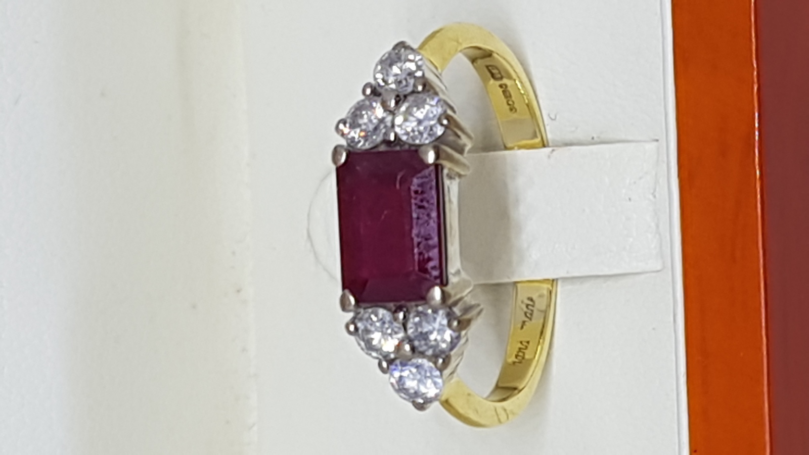 An 18 ct Yellow Gold Ring Set With Single Emerald Cut Ruby And Diamonds