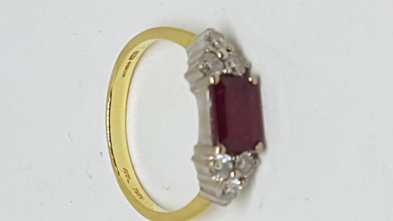 An 18 ct Yellow Gold Ring Set With Single Emerald Cut Ruby And Diamonds