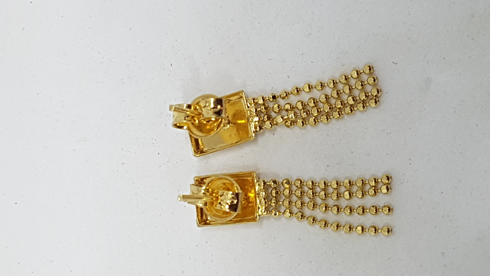 Discover our tri-coloured yellow metal pendant and earring suite. Textured with white and rose accents, it's a luxurious addition to any outfit. Explore now for a unique style boost!