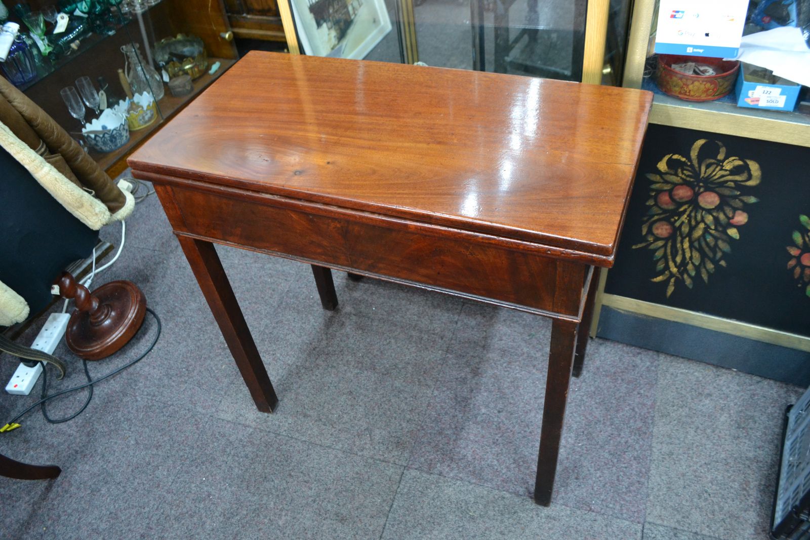 Discover our George III Mahogany card table. Despite wear on its green cover, it remains in reasonable condition. Shop now for vintage furniture delights!